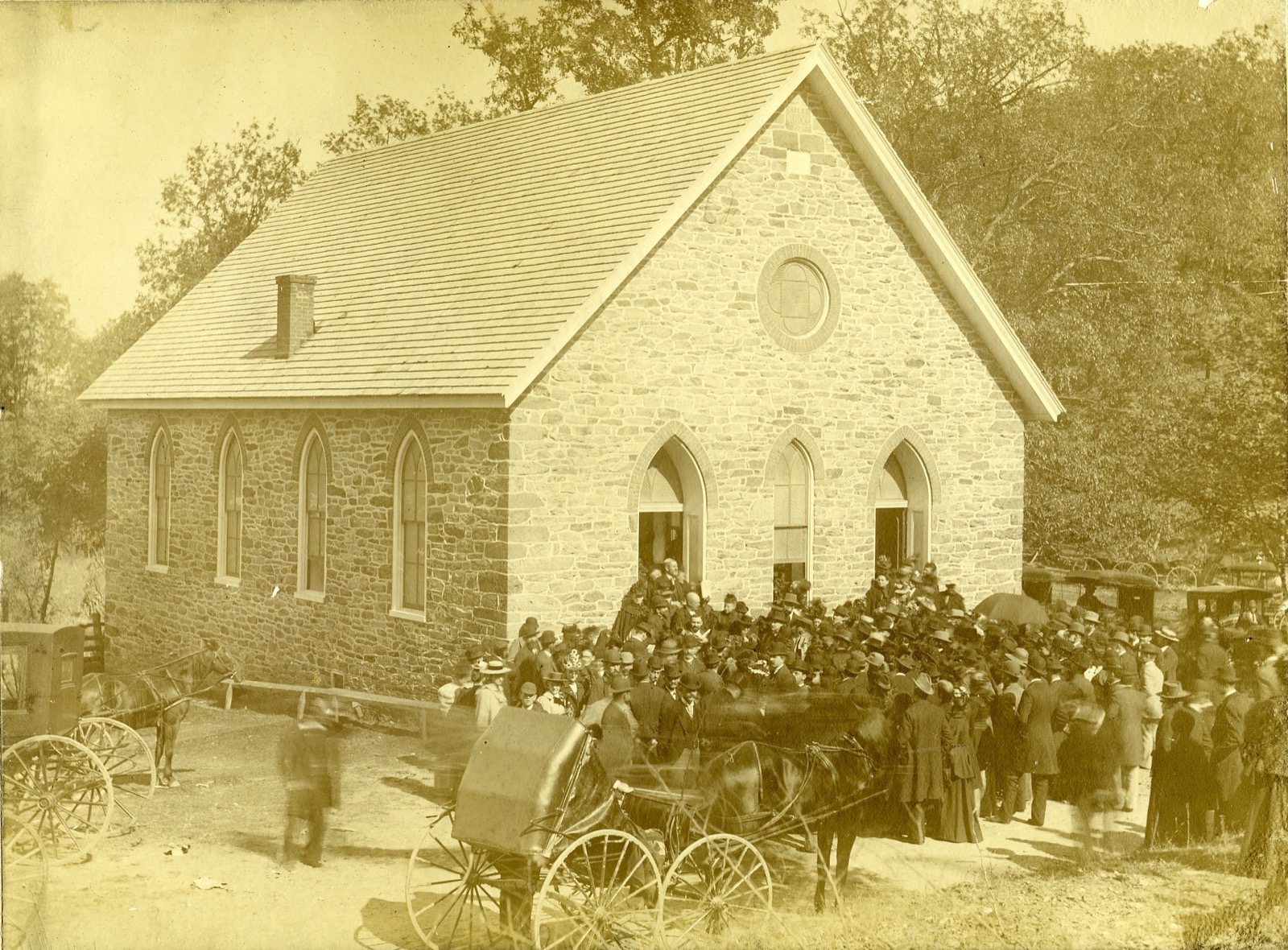 A photo of folks gathering after service, circa 1896.