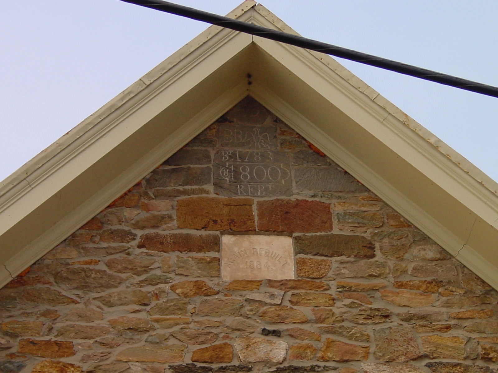 A photo of plaque stones that show the dates of construction and reconstruction.